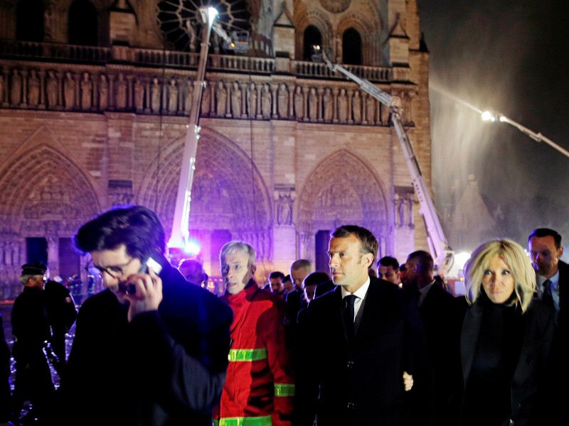 Staatschef Emmanuel Macron (M) machte sich zusammen mit seiner Frau Brigitte noch am Abend ein Bild von der Lage in Paris.